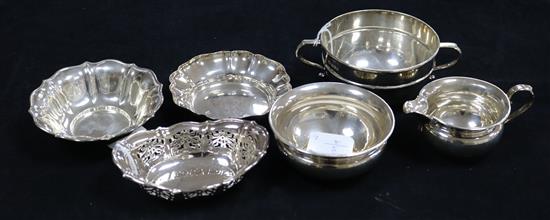 Two circular silver fluted bon bon dishes, a pierced oval bon bon dish, a two-handled sugar bowl and a small cream jug